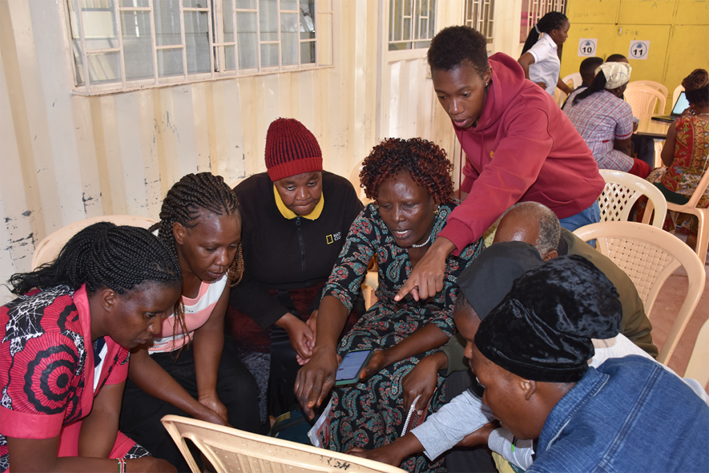 LCMC staff Joy Kesenwa showing the animators how to access the online sites that are beneficial to the children.
