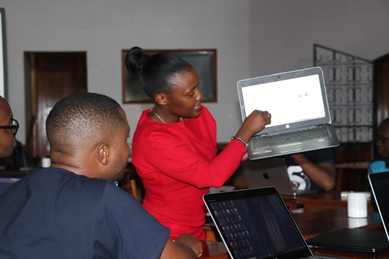 Susan Nzomo, a staff member at the Loyola Centre for Media and Communication, demonstrates how to easily generate spiritual content online using a laptop - LCMC | Media literacy education | Artificial Intelligence | Resilience | Formation | Media and communications training |Digital media literacy.- LCMC | Media literacy education | Artificial Intelligence | Resilience | Formation | Media and communications training |Digital media literacy